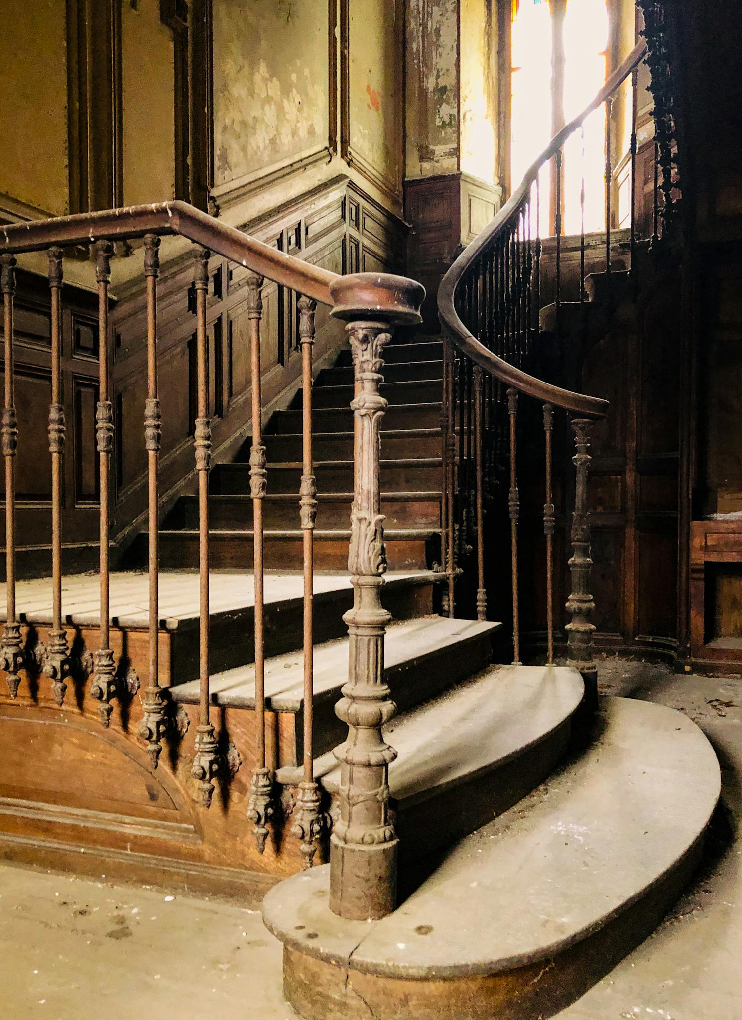 Explore the intricate details of an abandoned wooden staircase, rich with history and character.